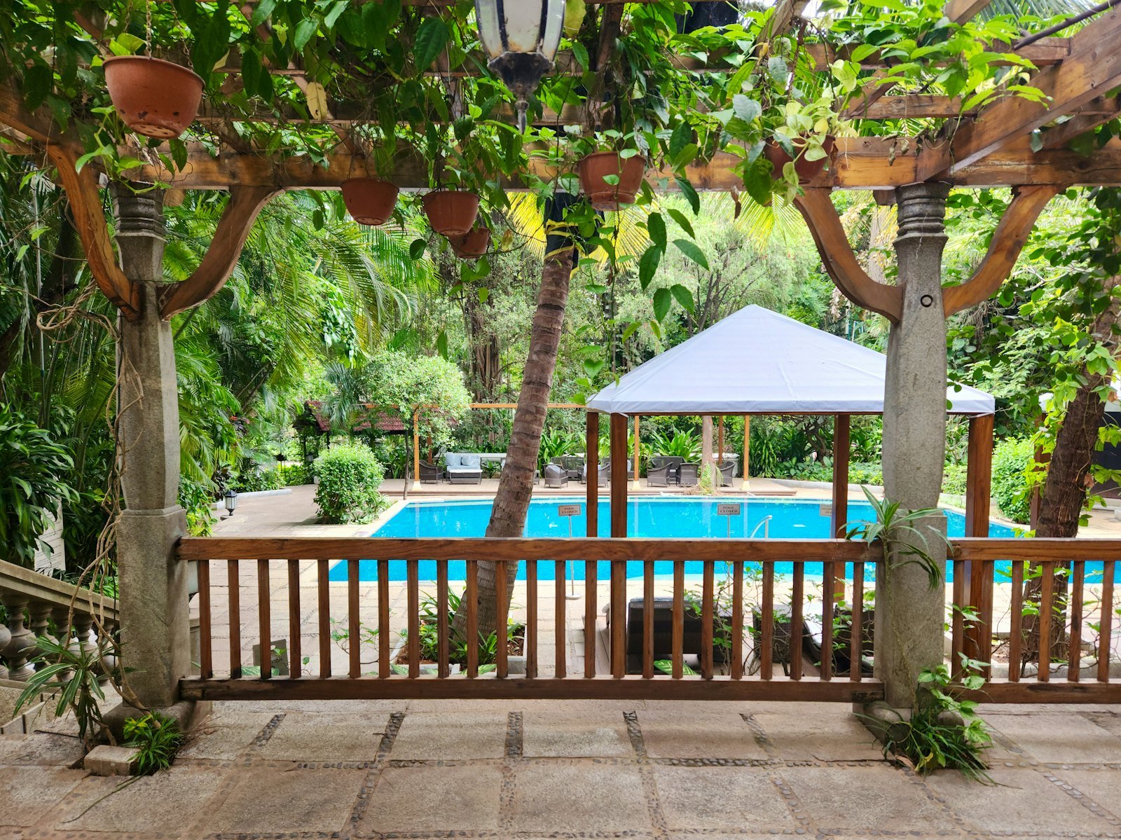 A shaded veranda looking onto a garden pool
